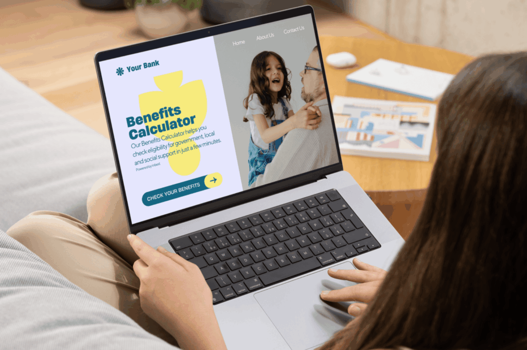 Person using a laptop showing a banking website with a Benefits Calculator and a “Check your benefits” button.